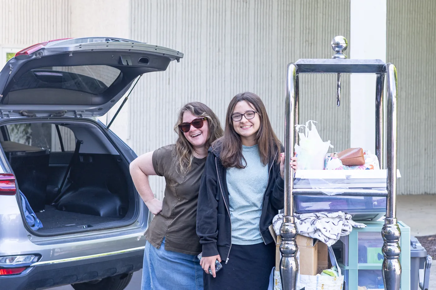 A student and family member arriving with belongings on move-in day
