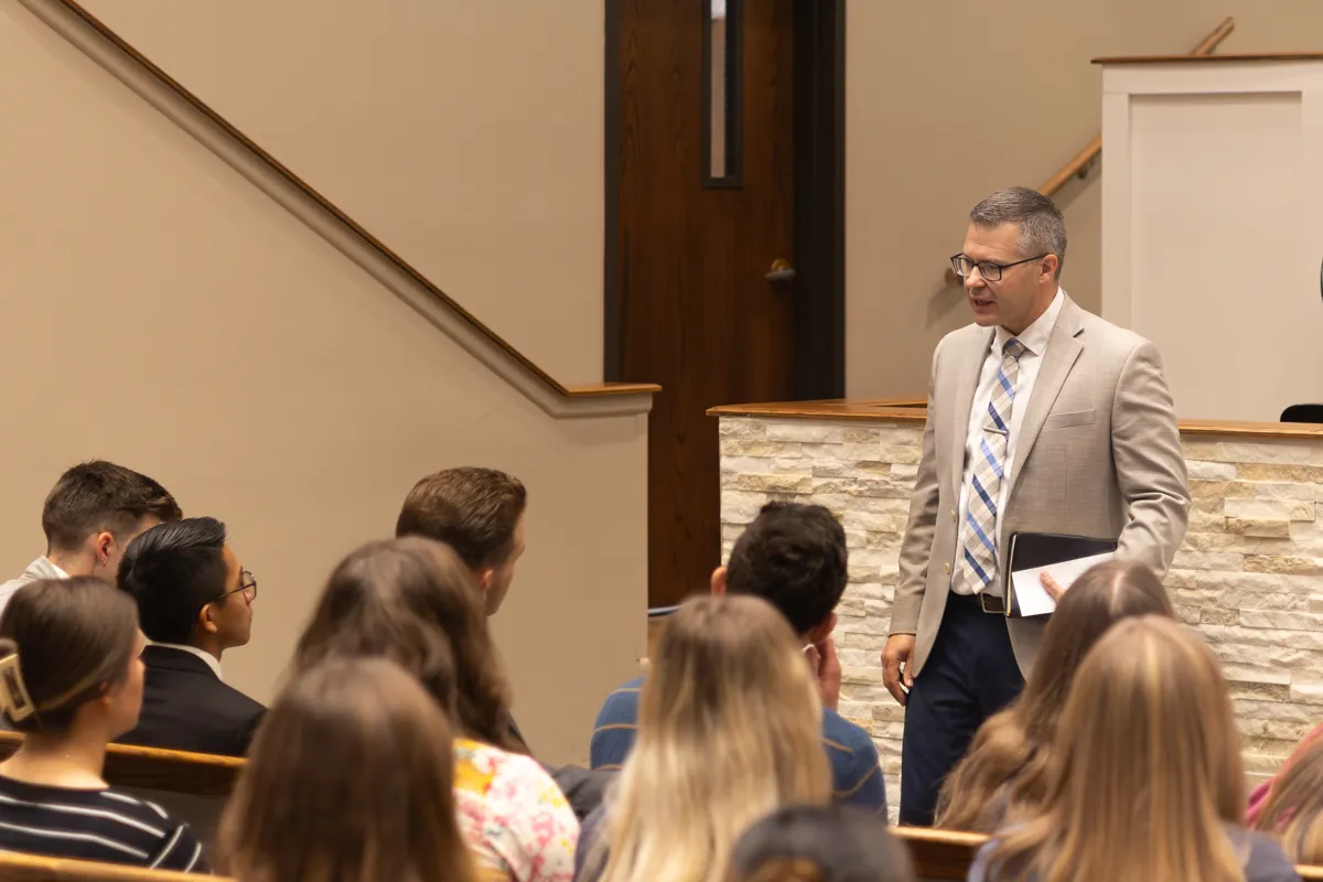 An instructor speaking personally with Providence students